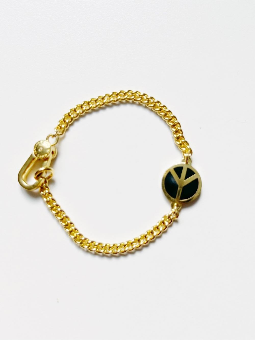 Marc Jacobs Gold Bracelet with Black Peace Sign Charm